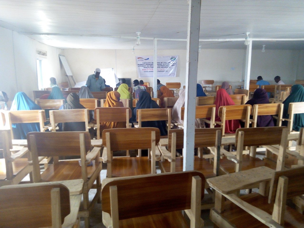 Women seated at desks during a JCC literacy and numeracy class