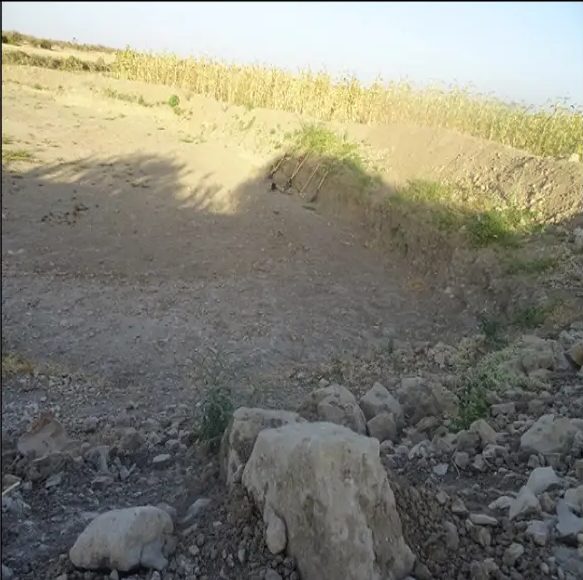 Reshaped embankment and cleared spillway channel after excavation work
